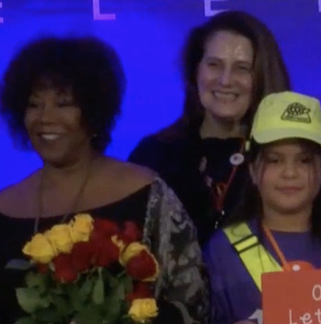 Ruby Bridges stands next to a teacher and student